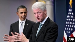 President Barack Obama looks on as former President Bill Clinton speaks in the briefing room of the White House in Washington, Friday, Dec. 10, 2010. (AP Photo/J. Scott Applewhite)