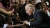 Vice President Joe Biden greets Lawrence Smith, 8, and Madison King, 9, both of Van Buren Township, Michigan, during a campaign stop at Renaissance High School in Detroit, Michigan, August 22, 2012.